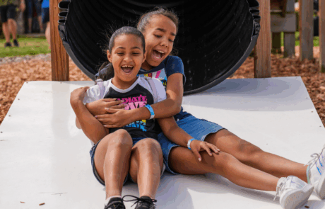 play yard girls on slide, summer fun on the farm, farm play yard