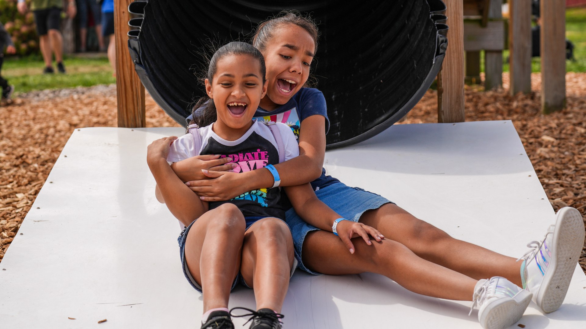 play yard girls on slide, summer fun on the farm, farm play yard